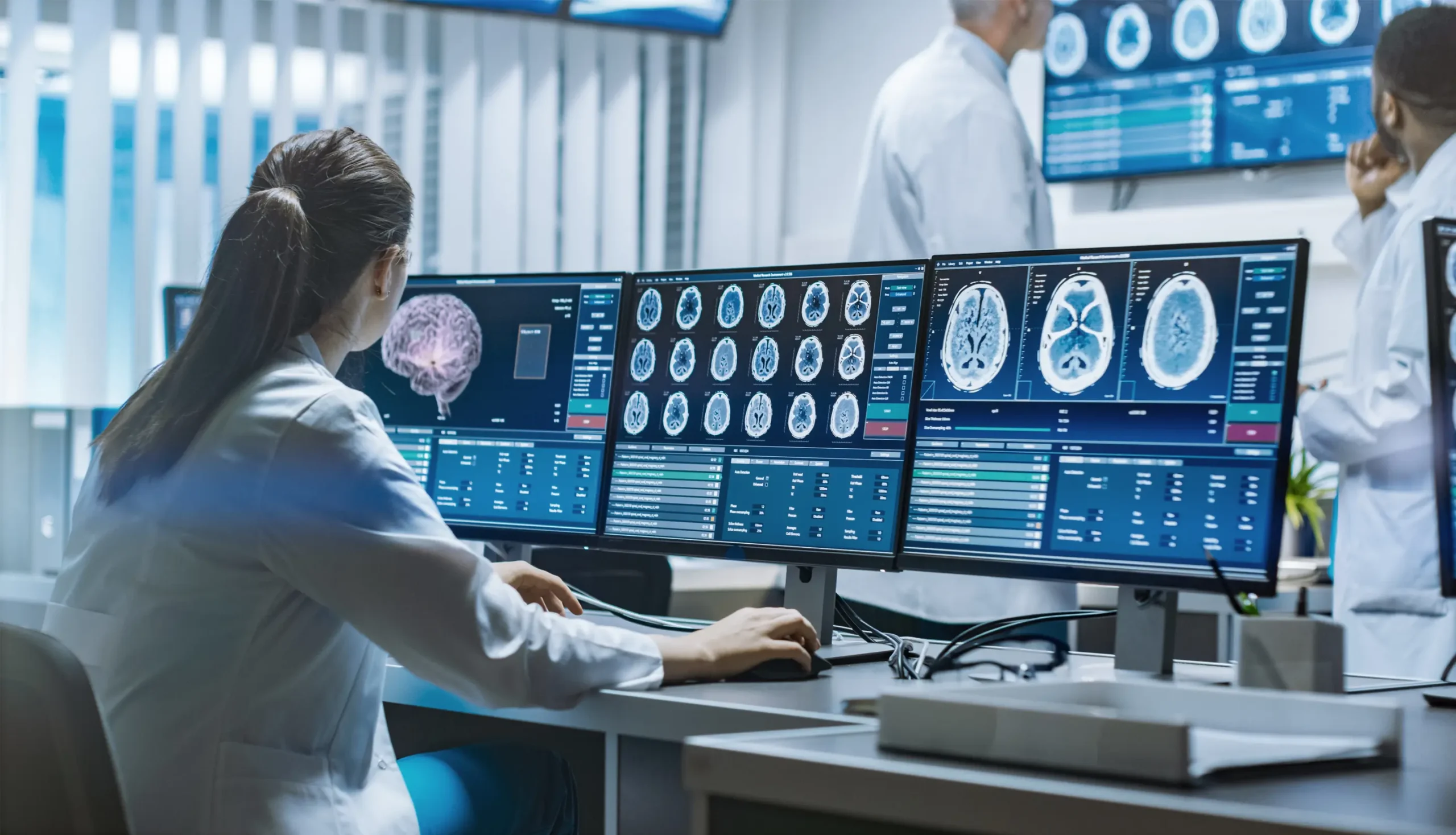 Radiology team reviewing brain scans and MRI workflow dashboards, illustrating imaging operations and monitoring readiness.